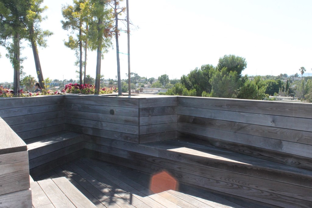 A wooden deck with steps and a bench.