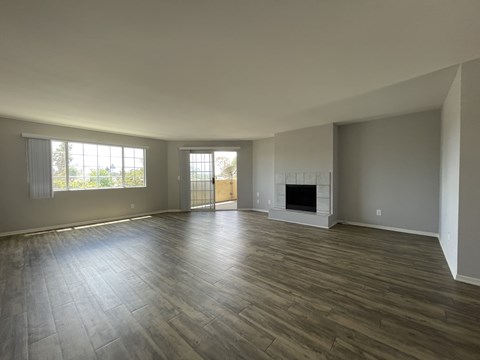 Bright living room with fireplace and glass door at Lido Apartments - 4280 Lindblade Dr, Los Angeles, CA