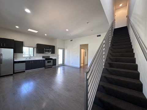 A spacious kitchen with a refrigerator, microwave, and oven.