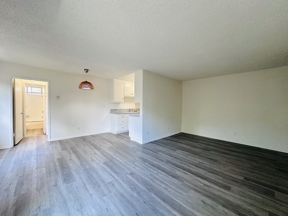 A room with a wooden floor and white walls.