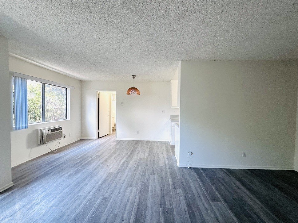 A room with a grey floor and white walls.