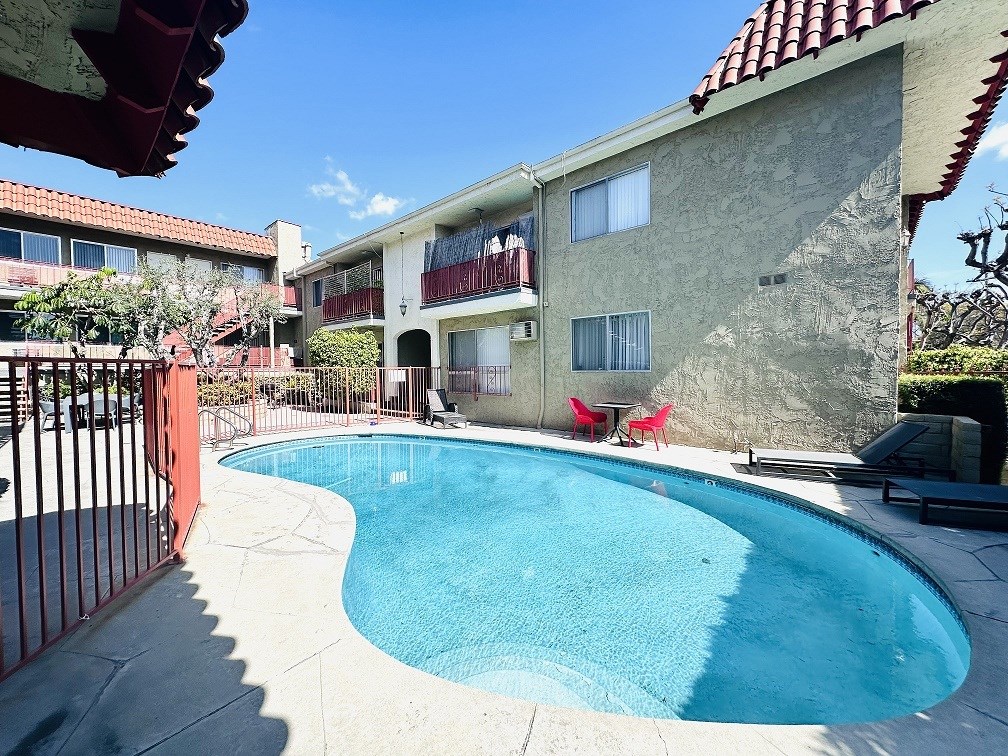 A pool in a courtyard surrounded by buildings.