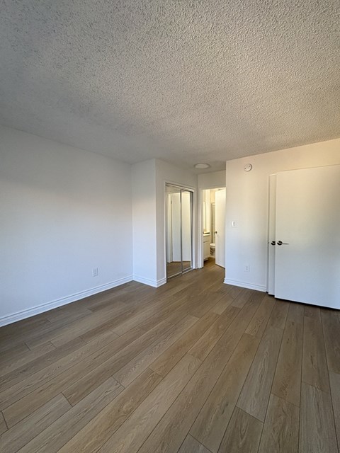 A room with wooden floors and white walls.