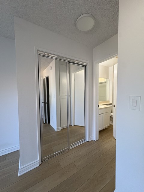 A white bathroom with a walk-in shower and a toilet.