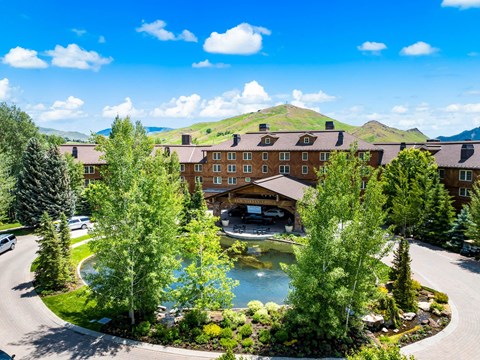 A resort with a pool and a mountain in the background.
