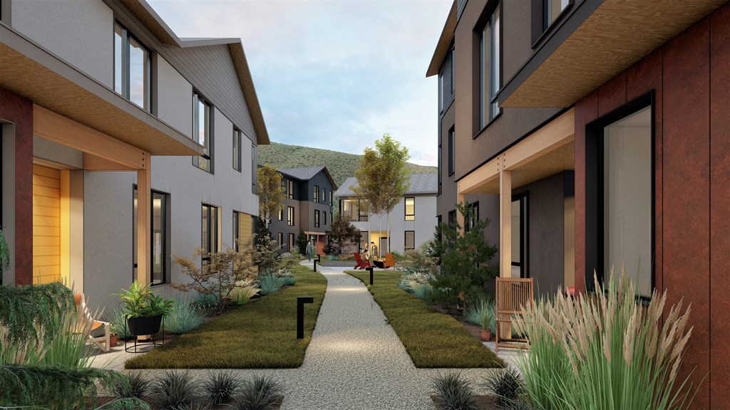 a rendering of a row of townhomes with a walkway between them a rendering of a row of townhomes with a walkway between them at Lido Apartment Homes @ Hailey, ID, Hailey