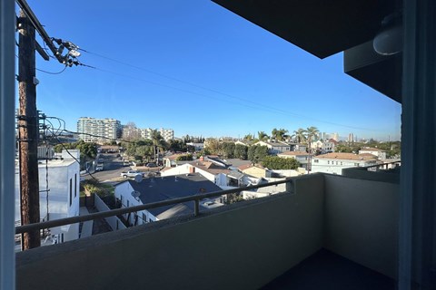 A view from a balcony overlooking a residential area.