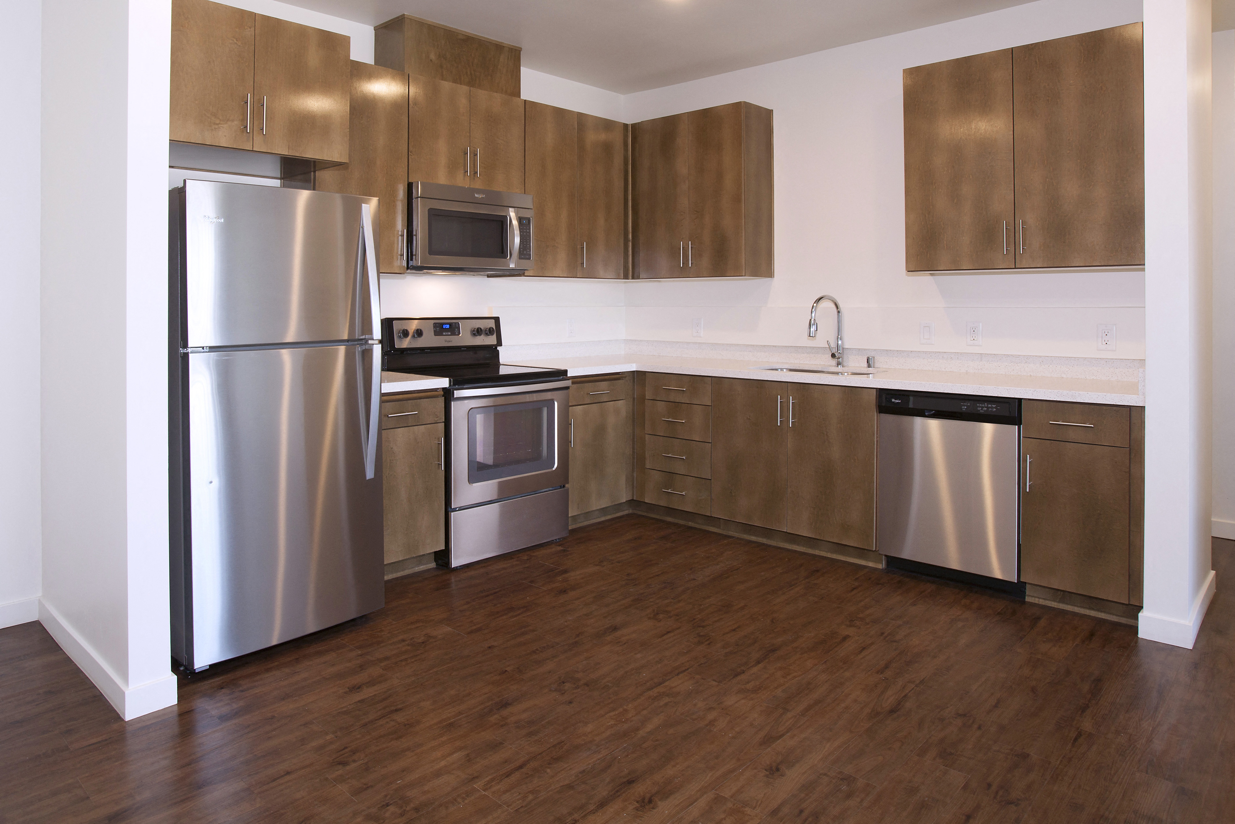 a kitchen with stainless steel appliances and wooden cabinets