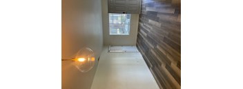 a hallway with a glass lamp and a window