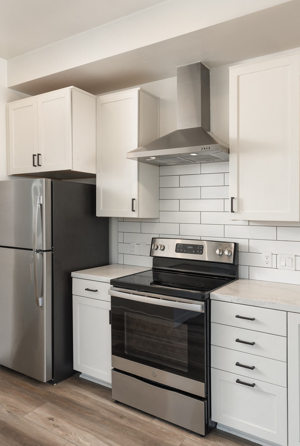 Studio kitchen with stainless steel appliances. Oven, fridge, and range hood pictured. at Plaza Riviera, Santa Barbara, California