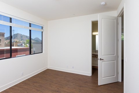 a bedroom with a large window and a door that leads to a bathroom at Roundhouse Place, California