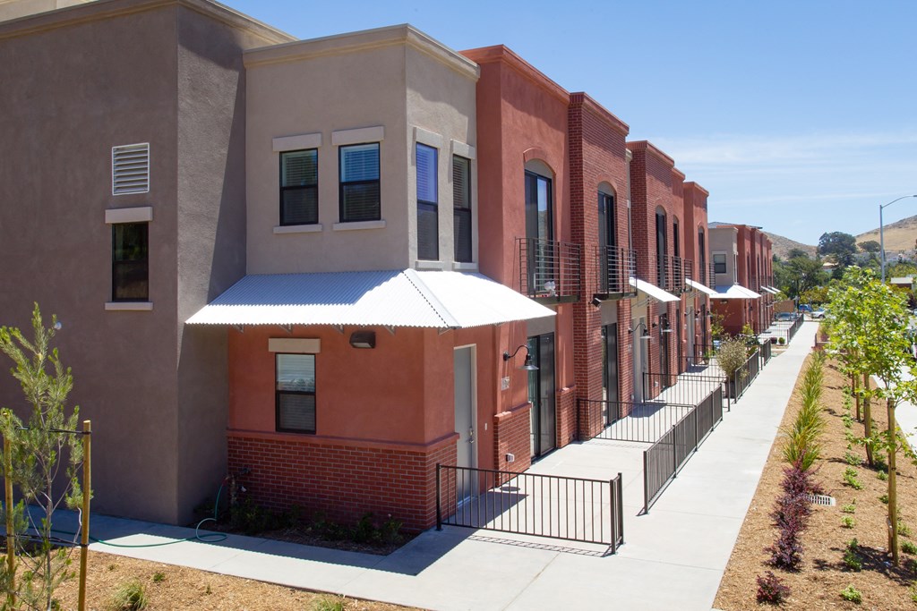 a row of apartment buildings with a sidewalk in front of them at Roundhouse Place, San Luis Obispo
