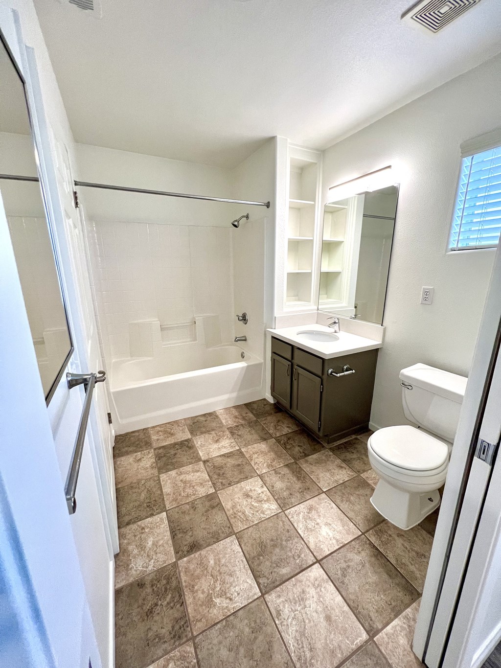 a bathroom with a toilet sink and bathtub  at Villa Mondavi, Bakersfield, CA