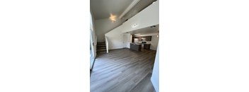 an empty living room with a staircase leading up to the second floor at Villa Mondavi, Bakersfield