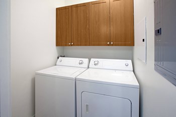 One and Two Bedroom Laundry Room with wall cabinets above side by side Washer and Dryer - Photo Gallery 21