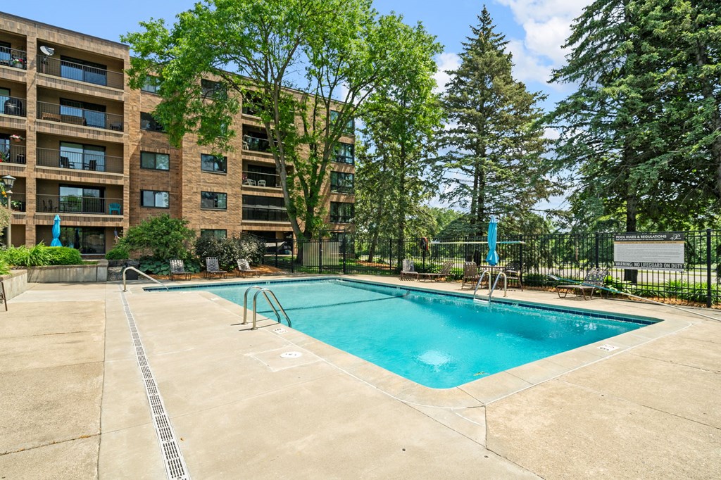 our apartments have a swimming pool and a building with trees