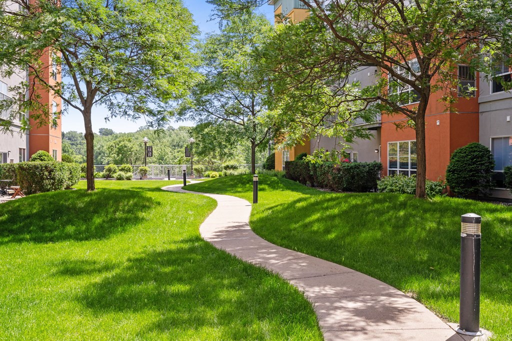 a path through the grass in front of a building