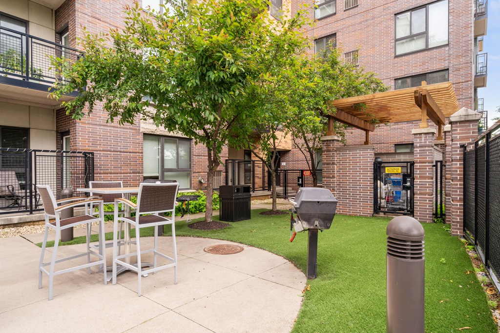our apartments offer a patio with tables and chairs and a grill