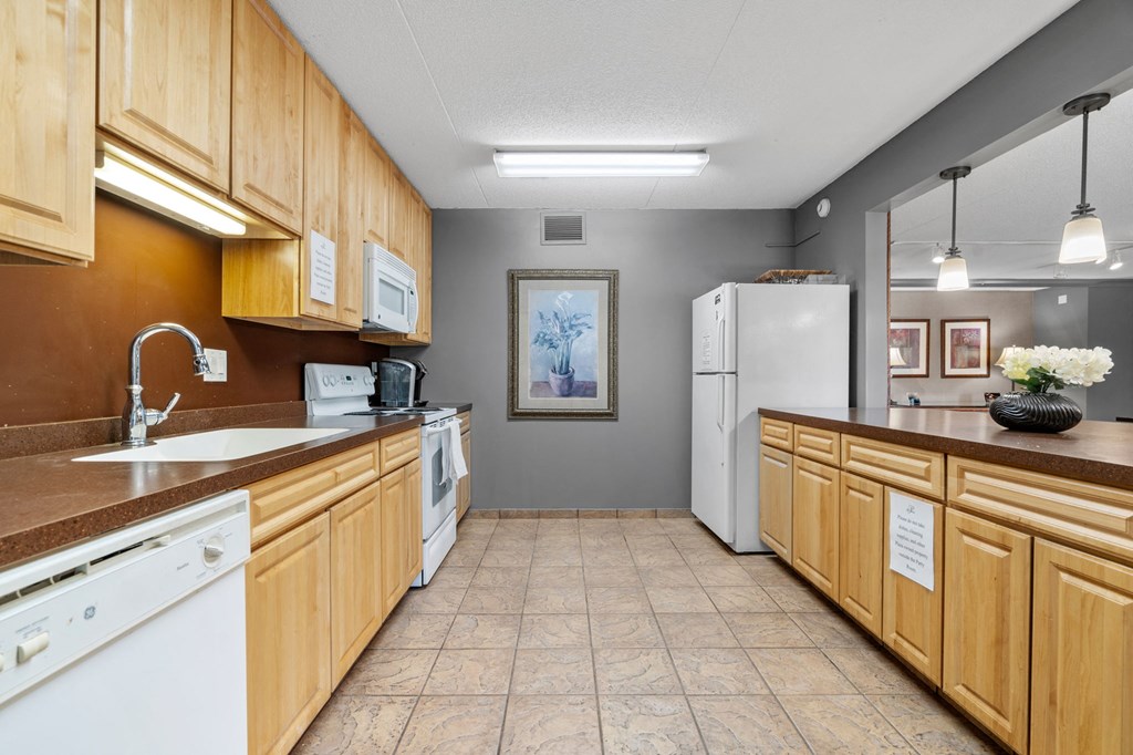 a kitchen with wooden cabinets and a sink and a refrigerator