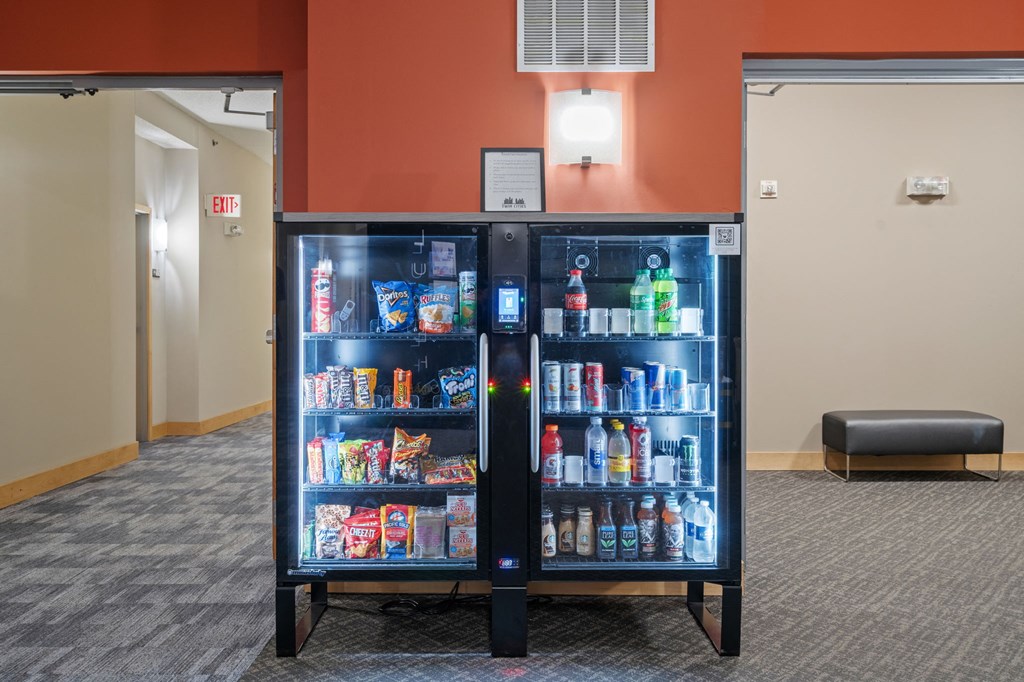 a cooler filled with drinks in a room