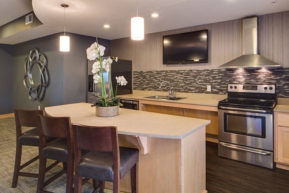 a kitchen with a center island and a table with chairs