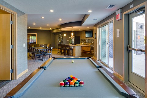 a game room with a pool table with balls on it