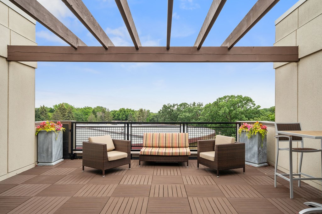 a patio with chairs and a table on a balcony