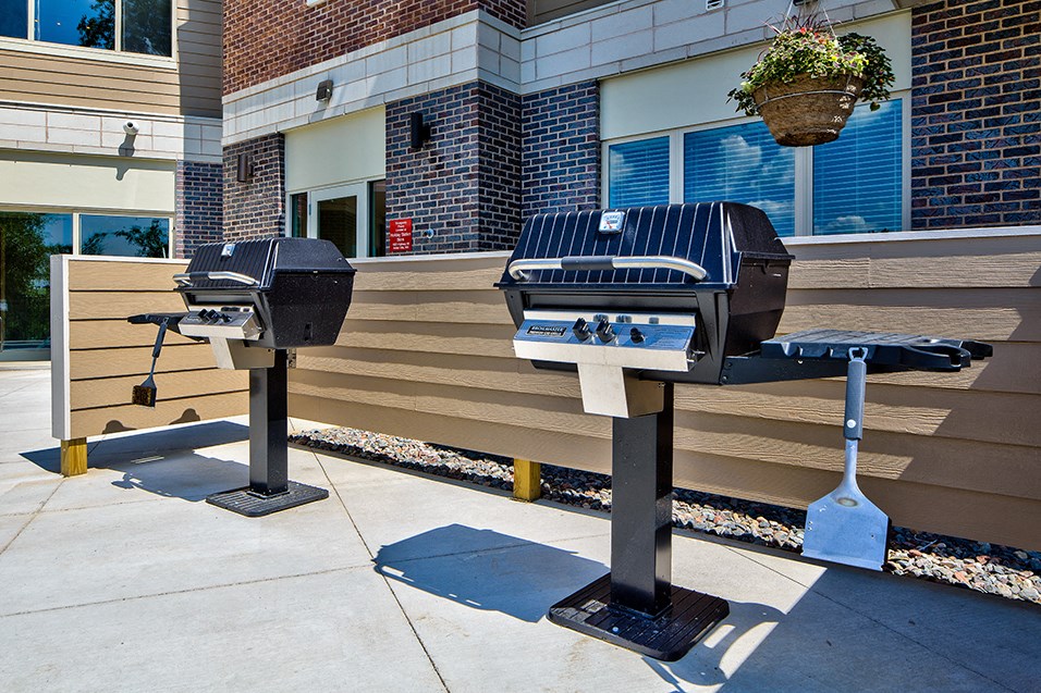two bbq pits in front of a building