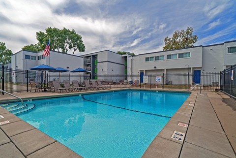 our apartments have a swimming pool with chairs and umbrellas