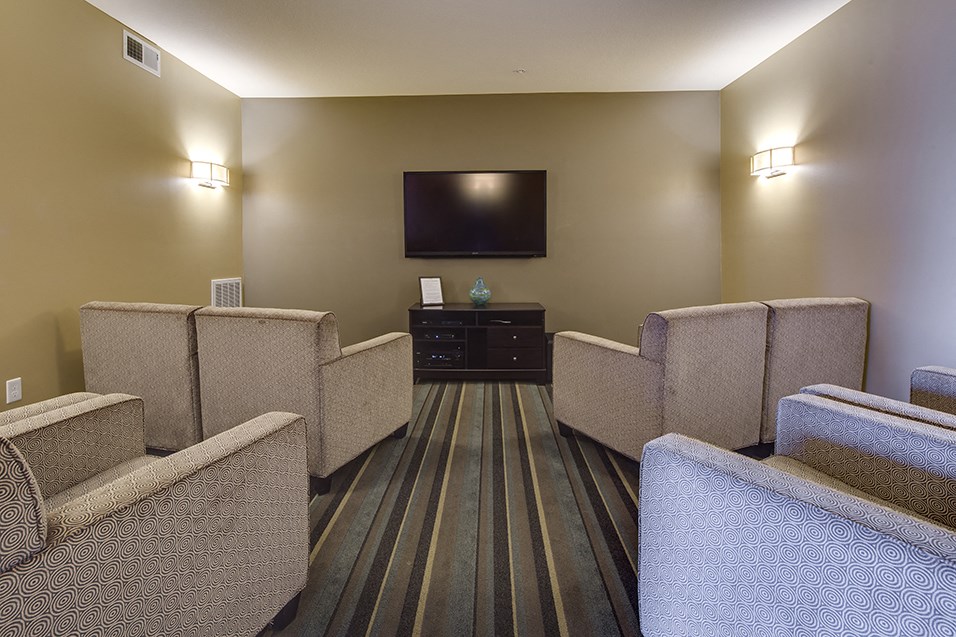 a room with chairs and a tv in the corner