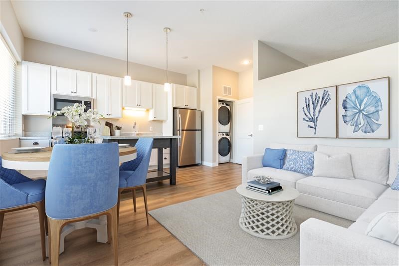A modern kitchen with a dining table and chairs.