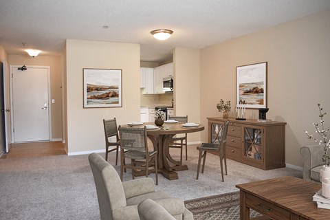 A dining room with a table set for four.
