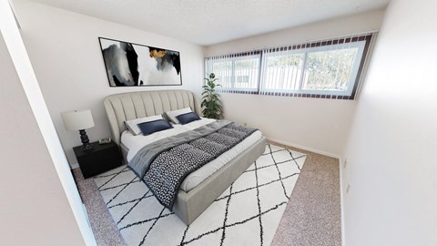 a bedroom with a bed and a large window