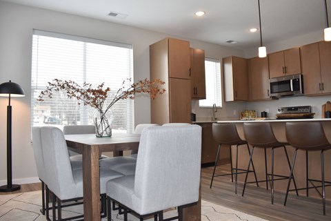 A dining room with a table and chairs.
