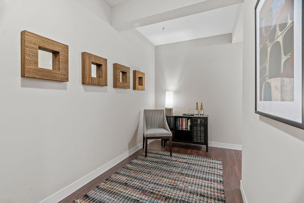 a bedroom with a desk and three small mirrors on the wall