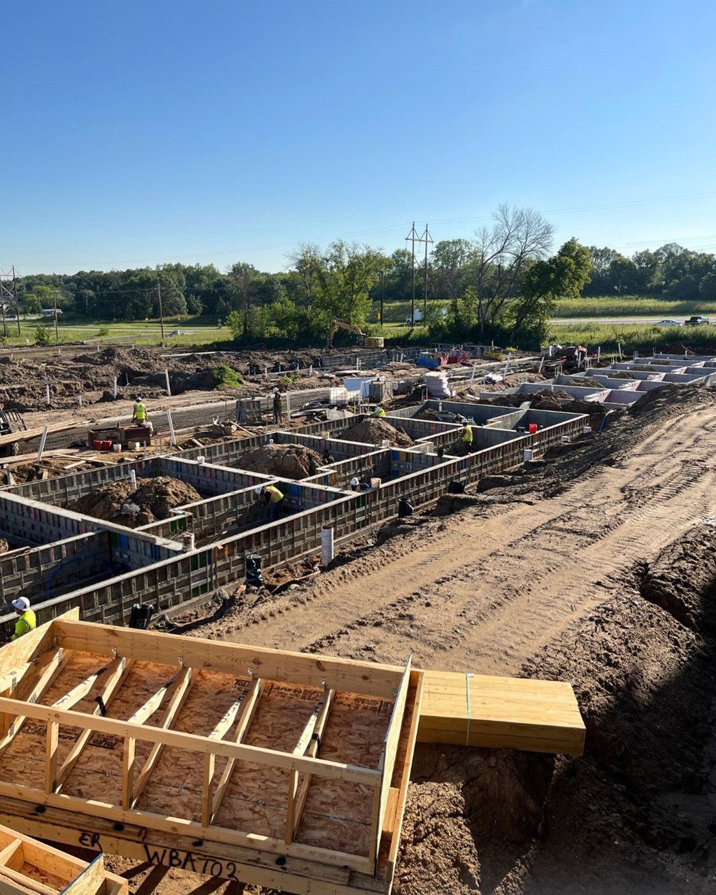 A construction site with a clear blue sky above.