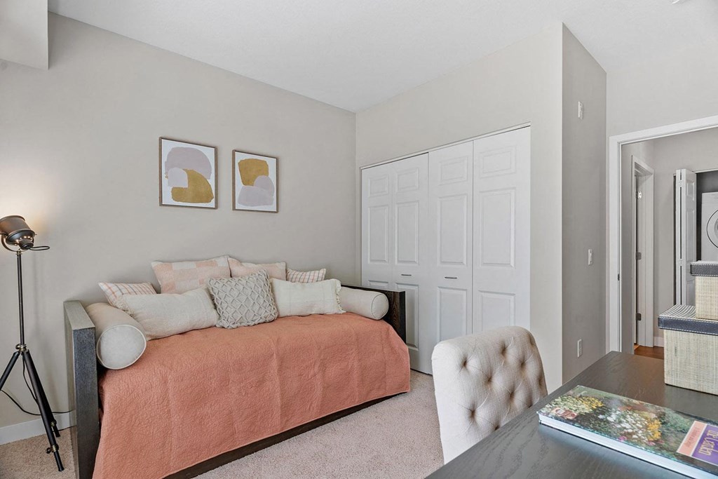 a bedroom with a bed and a desk