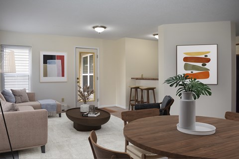 A living room with a brown table and a painting on the wall.
