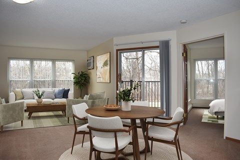 A dining room with a table set for six.