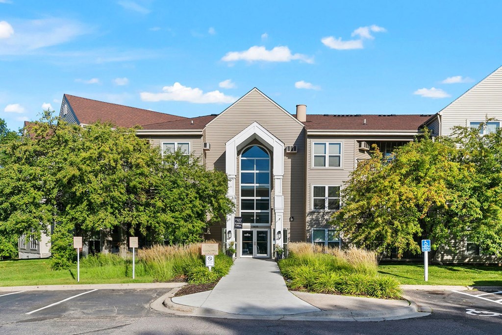 a building with a large window and a walkway in front of it
