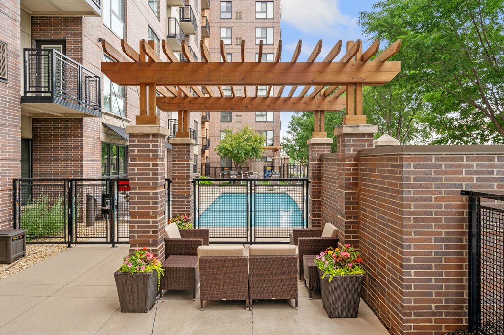 our apartments have a large patio with furniture and a pool