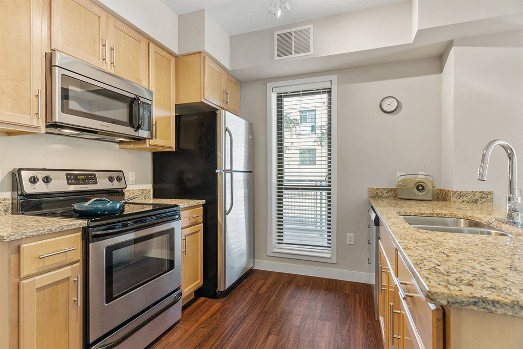 a kitchen with stainless steel appliances and granite counter tops