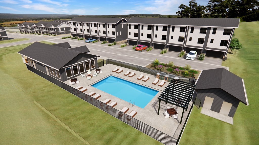 A resort with a swimming pool and a car parked in front of the building.