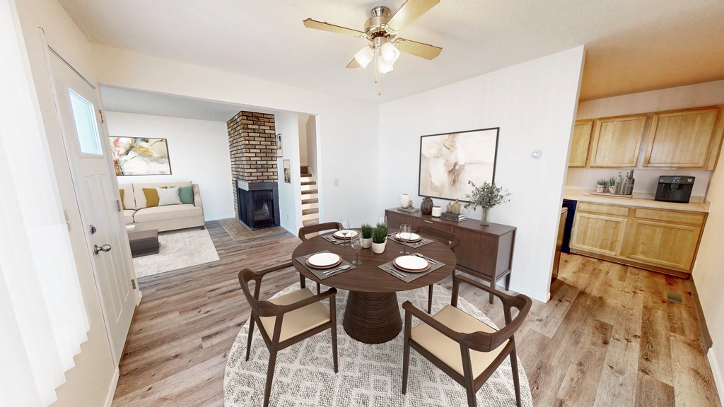 an open living room and dining room with a table and chairs