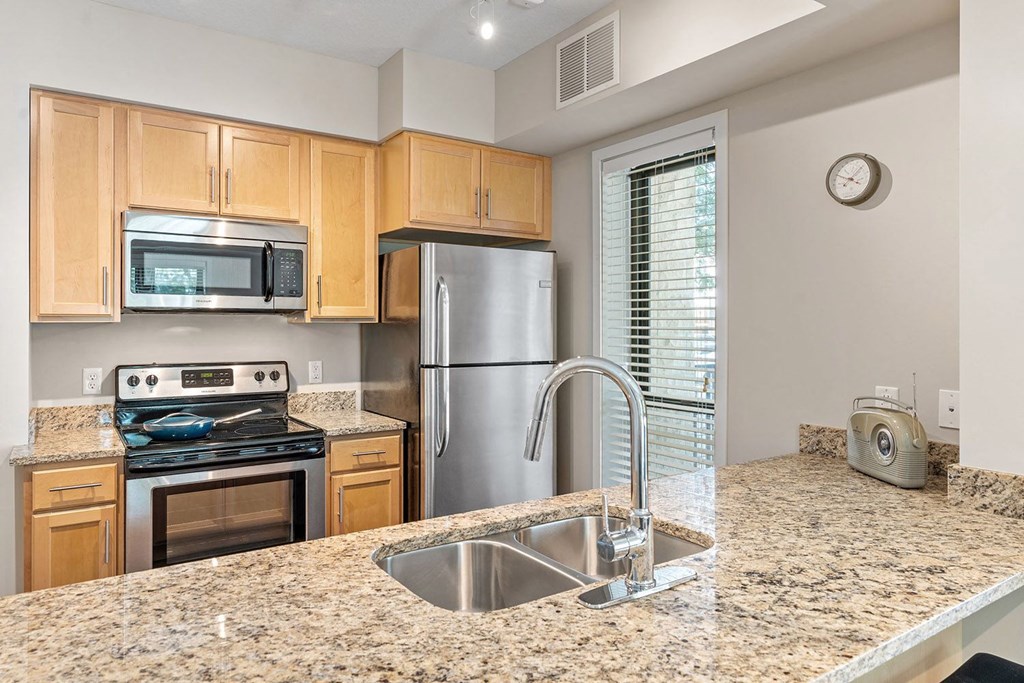 a kitchen with granite countertops and stainless steel appliances
