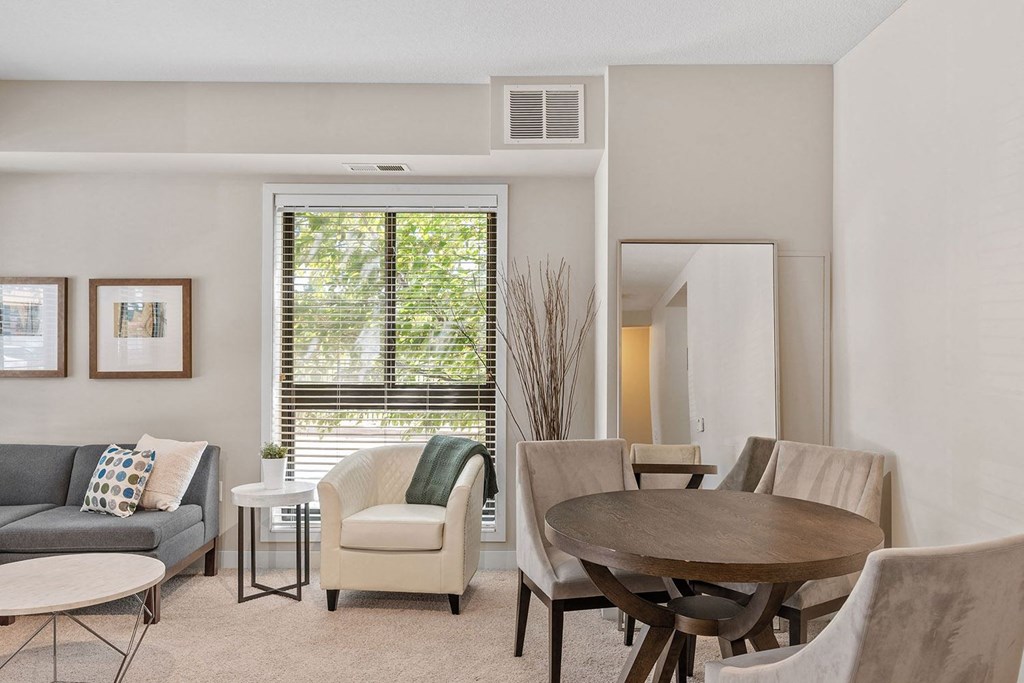 a living room with a table chairs and a couch