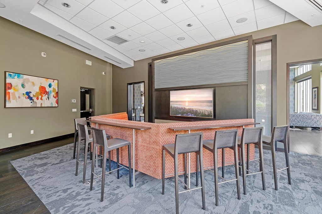 a seating area with chairs and a large screen tv