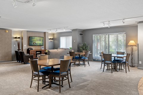 a living room and dining room with tables and chairs and a couch