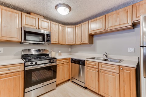 A kitchen with wooden cabinets and stainless steel appliances.