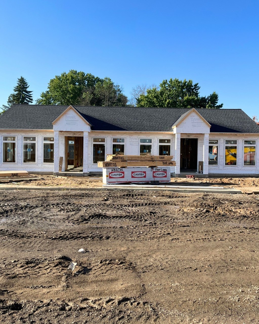 A construction site with a building under construction in the background.